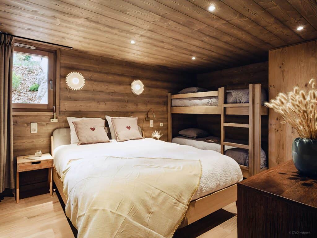 Cosy bedroom with a double bed and bunk beds.