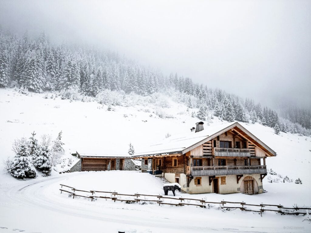 A traditional chalet in a snowy landscape.