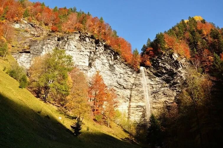 Waterfall in an autumn mountain landscape.