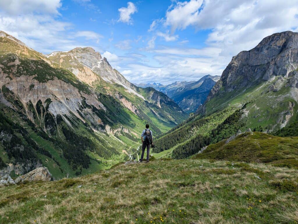 Solo hiker admiring a mountain landscape.